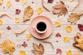 Flat lay composition with colorful Autumn cup of coffee and leaves on a color background. top view Royalty Free Stock Photo