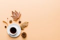 Flat lay composition with colorful Autumn cup of coffee and leaves on a color background. top view Royalty Free Stock Photo