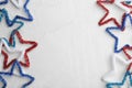 Flat lay composition of colorful decorative stars on light background. USA Independence Day