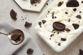 Flat lay composition with container of ice cream and chocolate cookies on grey Royalty Free Stock Photo