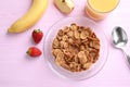 Flat lay composition with cornflakes on pink table. Healthy breakfast