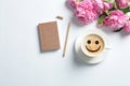 Flat lay composition with cup of coffee and smile on white background. Royalty Free Stock Photo