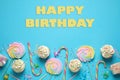 Flat lay composition with cupcakes on blue background. Happy Birthday Royalty Free Stock Photo