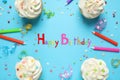 Flat lay composition with cupcakes on light blue. Happy Birthday Royalty Free Stock Photo