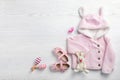 Flat lay composition with cute clothes and space for text on white wooden background. Royalty Free Stock Photo