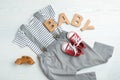 Flat lay composition with cute clothes on white wooden background. Royalty Free Stock Photo