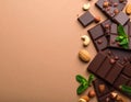 Dark chocolate bars with nuts and mint leaves on brown background Royalty Free Stock Photo