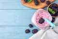 Flat lay composition with delicious blackberry smoothie on blue wooden background Royalty Free Stock Photo