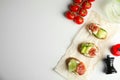 Flat lay composition with delicious bruschettas on white table