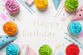 Flat lay composition with cupcakes and text Happy Birthday on white background Royalty Free Stock Photo