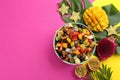 Flat lay composition with delicious exotic fruit salad on color background. Space for text Royalty Free Stock Photo