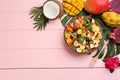 Flat lay composition with delicious exotic fruit salad on pink wooden table. Space for text Royalty Free Stock Photo