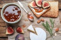 Flat lay composition with delicious fig jam on wooden table