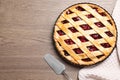 Flat lay composition with delicious fresh cherry pie on wooden table. Space for text Royalty Free Stock Photo