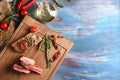 Flat lay composition with delicious grilled meat, rosemary and vegetables on wooden background