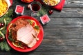 Flat lay composition with delicious ham served on wooden table, space for text. Christmas dinner Royalty Free Stock Photo