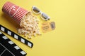 Flat lay composition with popcorn on yellow background. Space for text Royalty Free Stock Photo