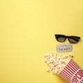 Flat lay composition with delicious popcorn on yellow background. Space for text Royalty Free Stock Photo