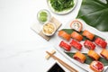 Flat lay composition with delicious sushi rolls on white marble table. Space for text Royalty Free Stock Photo