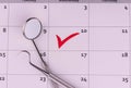 Flat lay composition with dentist tools and calendar and marked appointment by dentist. Royalty Free Stock Photo