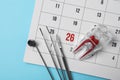 Flat lay composition with dentist tools, tooth model and calendar