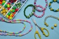 Flat lay composition with different colorful beads on light blue background Royalty Free Stock Photo