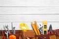 Flat lay composition with different construction tools on white wooden background