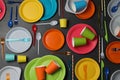 Flat lay composition with different disposable tableware on black background