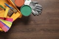 Flat lay composition with different painter\'s tools on wooden table, space for text. Decorating and design Royalty Free Stock Photo