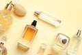 Flat lay composition with different perfume bottles on yellow background