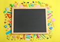 Flat lay composition with different school stationery and small chalkboard Royalty Free Stock Photo