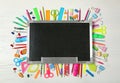 Flat lay composition with different school stationery and small chalkboard Royalty Free Stock Photo