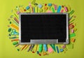 Flat lay composition with different school stationery and small chalkboard Royalty Free Stock Photo