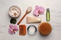 Flat lay composition with different spa products and flowers on white marble table Royalty Free Stock Photo