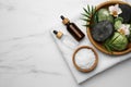 Flat lay composition with different spa products and flowers on white marble table. Space for text Royalty Free Stock Photo