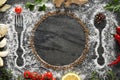 Flat lay composition with different spices, silhouettes of cutlery and plate on grey marble background. Space for text Royalty Free Stock Photo