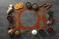 Flat lay composition with different spices, silhouettes of cutlery and plate on grey table. Space for text Royalty Free Stock Photo