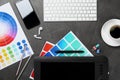 Flat lay composition with digital devices and color palettes on background. Graphic designer`s workplace