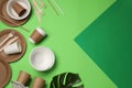 Flat lay composition with disposable tableware on green background, space for text Royalty Free Stock Photo