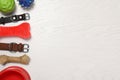 Flat lay composition with dog collars and toys on white wooden table. Space for text Royalty Free Stock Photo