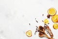 Flat lay composition from Dried citrus fruits with cinnamon, clove and star anise on a white table. Top view. Place for text. Royalty Free Stock Photo