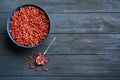 Flat lay composition with dried goji berries on blue wooden table. Healthy superfood