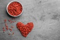 Flat lay composition with dried goji berries on grey table. Healthy superfood