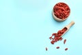 Flat lay composition with dried goji berries on light blue background. Healthy superfood