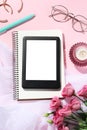 Flat lay composition with e-book reader, notebook and glasses on pink background. Space for text Royalty Free Stock Photo