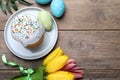 Flat lay composition with Easter cake and painted eggs on wooden table. Space for text Royalty Free Stock Photo