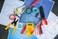 Flat lay composition with electrical tools and house plans on wooden background Royalty Free Stock Photo