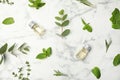 Flat lay composition with essential oil in bottles and different herbs Royalty Free Stock Photo