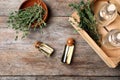 Flat lay composition with essential oil in glass bottles and thyme