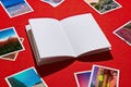 Open Blank Notebook with Polaroid Photos on Red Studio Desk Royalty Free Stock Photo